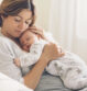 Loving mom carying of her newborn baby at home. Bright portrait of happy mum holding sleeping infant child on hands. Mother hugging her little 2 months old son.